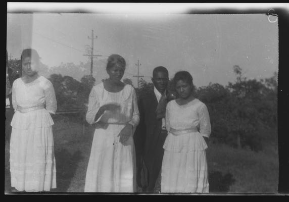 Negative of unidentified man and three women