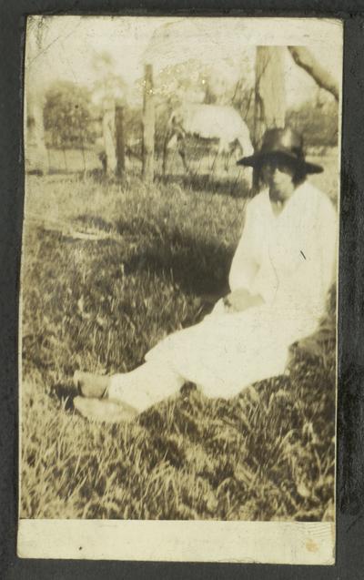 Page 2 [L]: Unidentified black woman sitting in grass