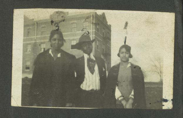 Page 5 [R]: Unidentified black man and two women