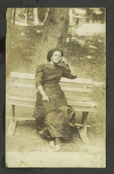 Page 15: Unidentified black woman sitting on bench