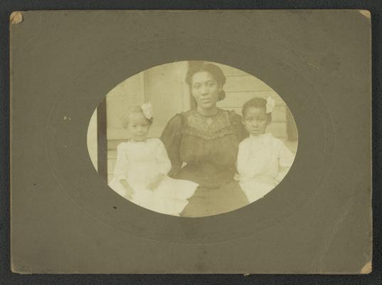 Portrait of an unidentified black woman with two young girls