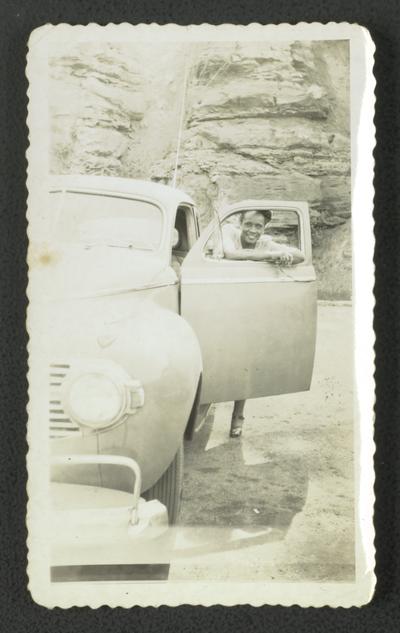 On top of Norris dam; Mrs. Dorothy Draper, Dorothy posing behind door of car