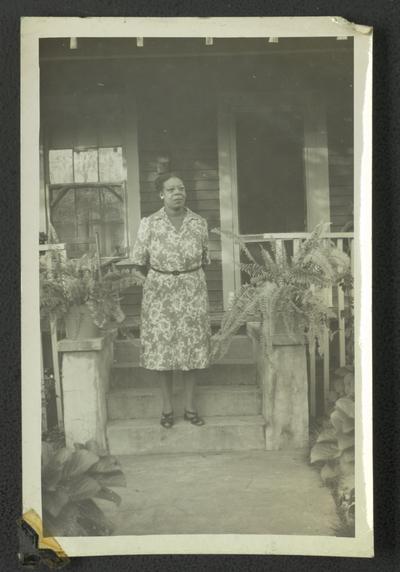 Miss Maurice standing on steps of house in Bay St. Louis, Mississippi