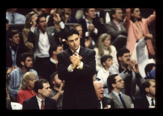 Rick Pitino applauding play, Keightley and fans in background; UK vs. Ole Miss