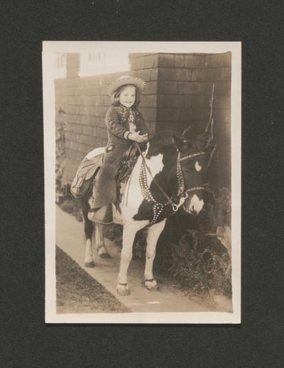 Two photos in one folder. Each is of a child on a pony. Susan E. Wilson: 5 [five] years. Patsy Wilson: 4 [four] years. San Diego. Jan. 1950