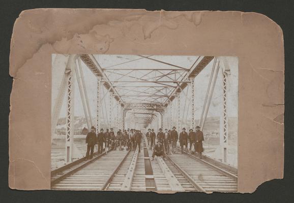 Workmen on a railroad bridge