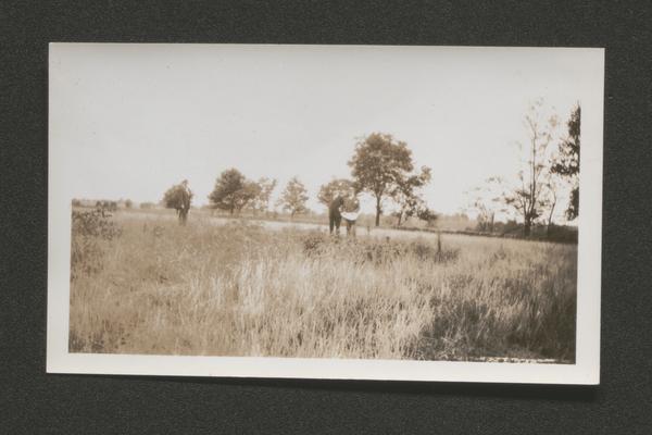 Three men in a field