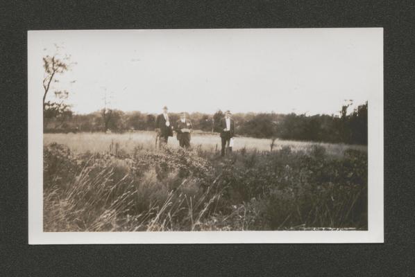 Three men in a field