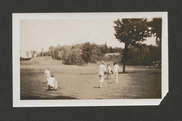 Five men on a golf green