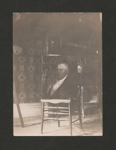 Portrait of a man sitting on a chair