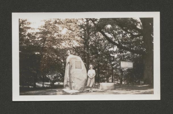 Mary Shelby Wilson standing beside a memorial marker