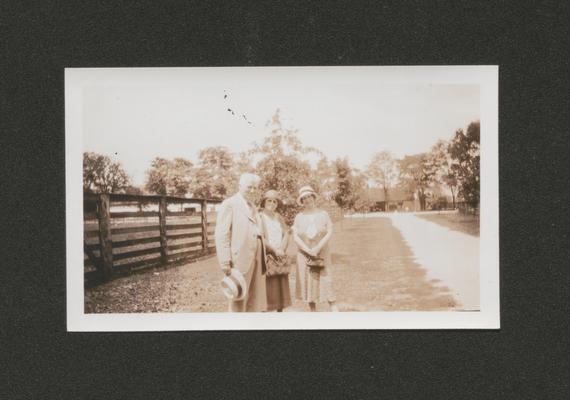 Mary Shelby Wilson, a man, and a woman standing by a fence