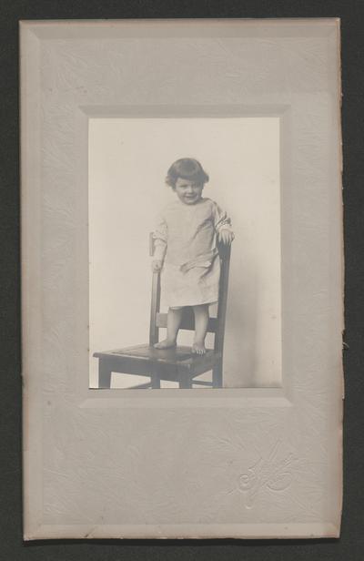 Child standing on a chair