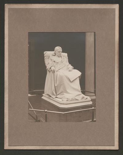 Statue of a man sitting in a chair