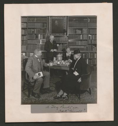 Two men and two women at A Tea Party at 'Oak Knoll.'