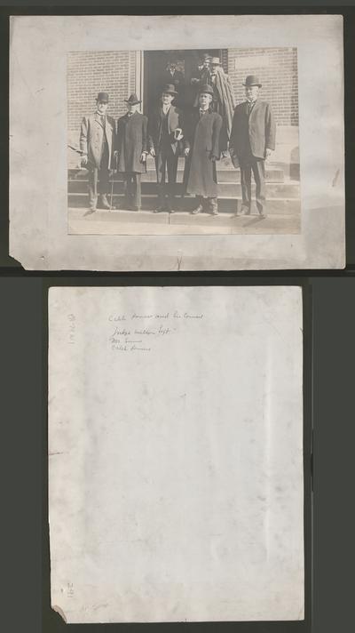 Group of five men on steps. Caleb Powers and his counsel. Judge [Samuel M.] Wilson on left. Mr. Sims. Caleb Powers