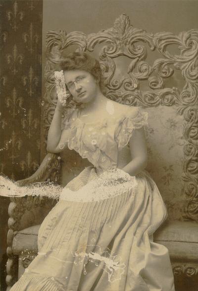 Young woman sitting in an ornate chair; Mullen, Lex., KY