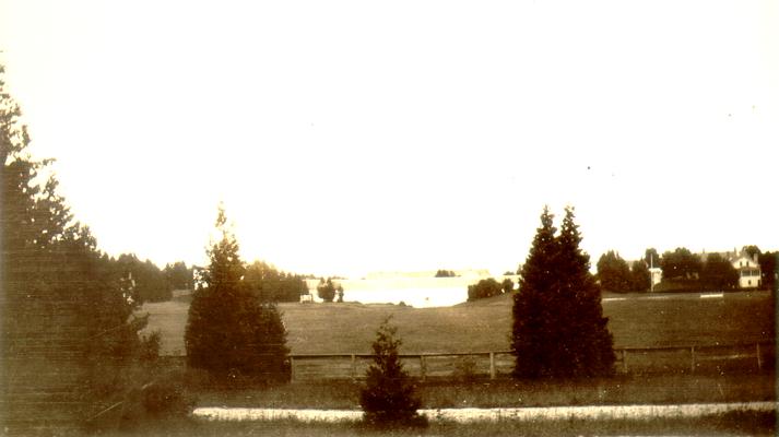 View from trees of a barn and pasture