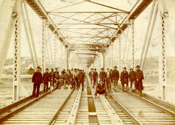 Workmen on a railroad bridge