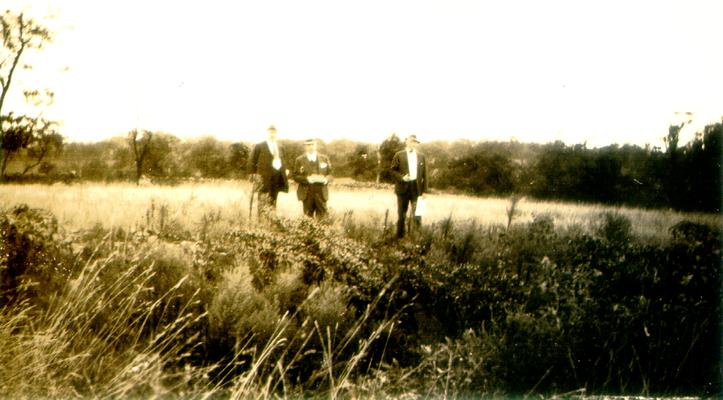 Three men in a field