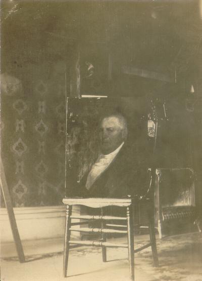 Portrait of a man sitting on a chair