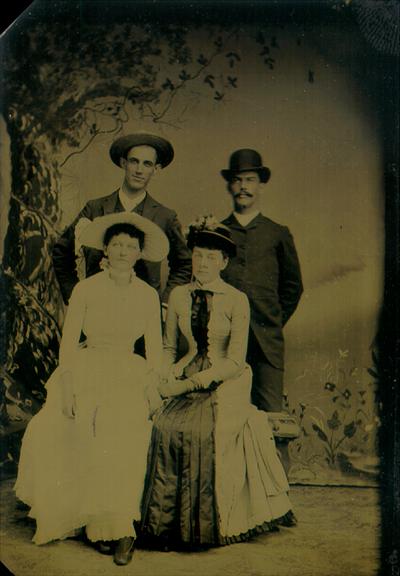 Tin type in paper fold, of two women and two men