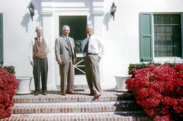 David, Evan and Edmund standing on porch steps (Color photo)