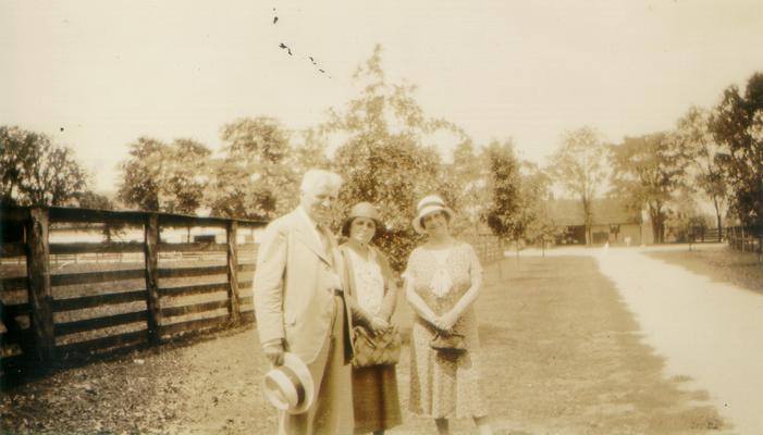Mary Shelby Wilson, a man, and a woman standing by a fence