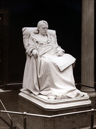 Statue of a man sitting in a chair
