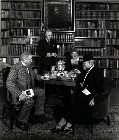 Two men and two women at A Tea Party at 'Oak Knoll.'