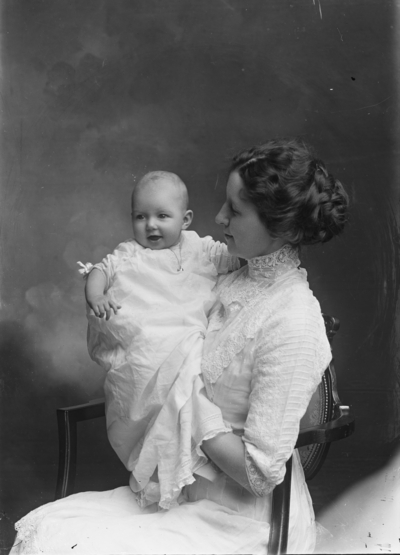 Portrait of a woman holding a baby identified as 