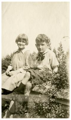 Two unidentified children in a garden