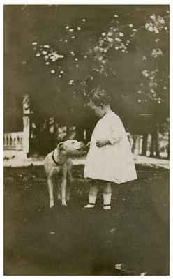 Unidentified infant with dog