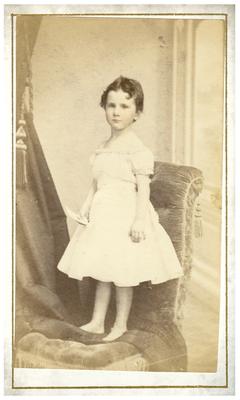 Girl, posed standing in chair, handwritten on back in ink 