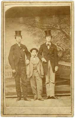 Unidentified group, two men and a boy