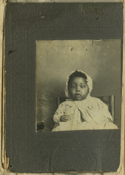 Unidentified African American female infant ; photo remains within album and is located on page 27