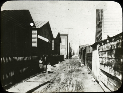 Unidentified African American female and child in an alley