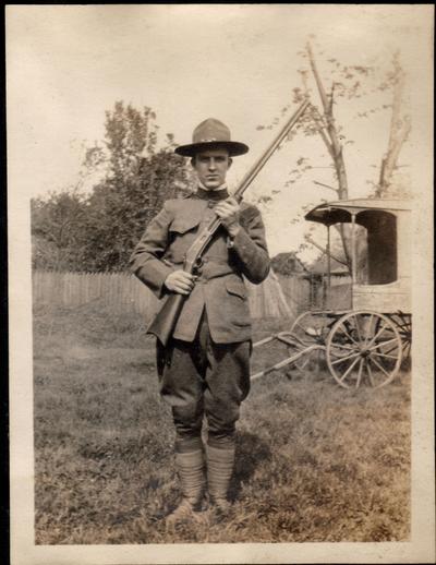 Forrest Bronaugh in World War I uniform with family shotgun