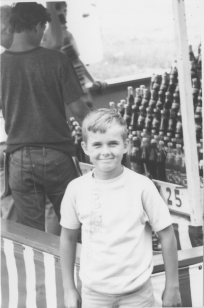 Series S43: Spencer Co. fair, boy in front of bottles