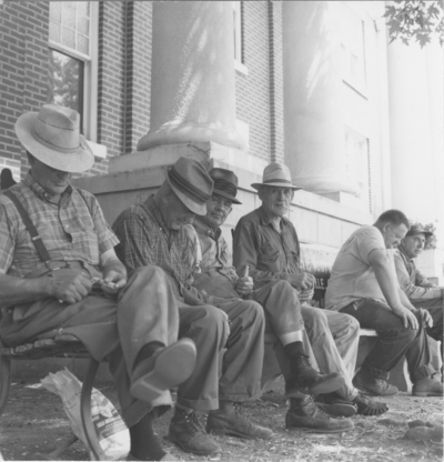 Taylorsville, men sitting in front of courthouse