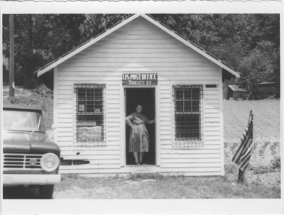 Series SF-26-SF3: Clay Co., Tanksley Post Office with post master standing in door
