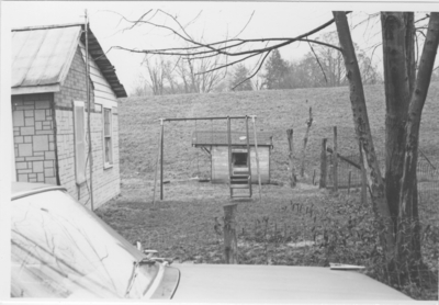Series S- S7: Taylorsville (Ky.), swing set in yard butting up to levee
