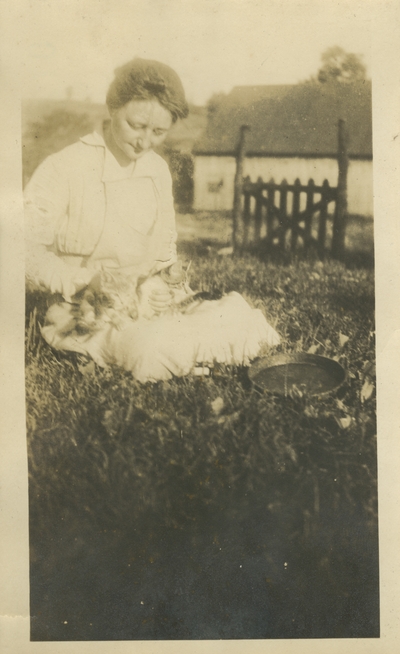 woman holding two cats; same photo as #41