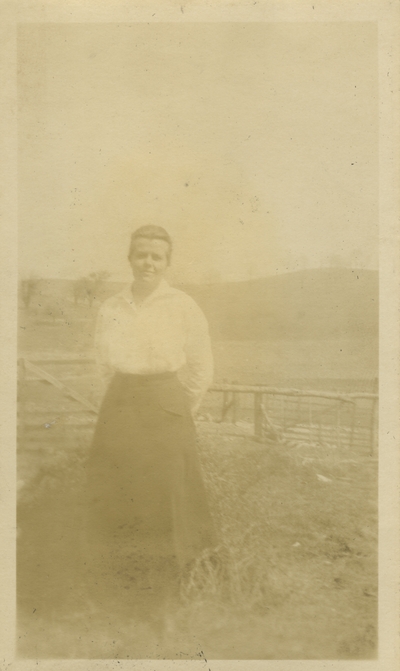 unidentified woman standing by field