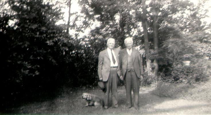 DeGroate, Sam Wilson, and dog in yard