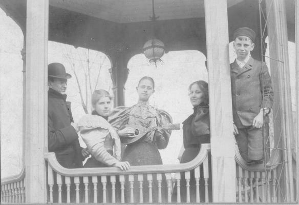 Five members of the Shelby family; one is playing a mandolin