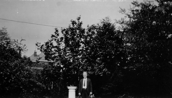 Samuel M. Wilson standing by a sun dial