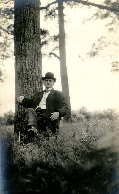 Payne's Depot. Man sitting next to tree