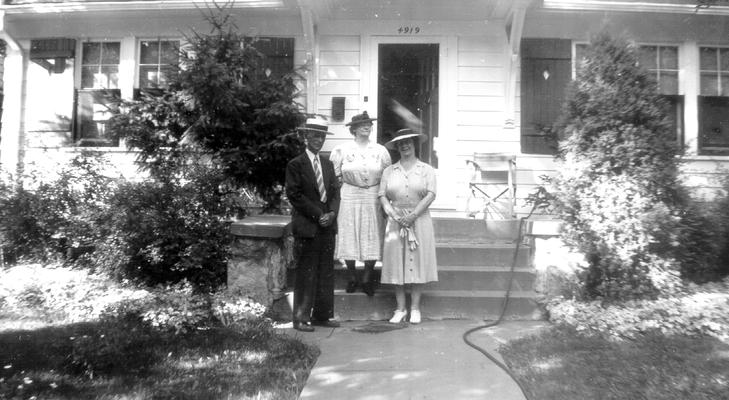 Mary Shelby Wilson and an unidentified man and woman in front of a house