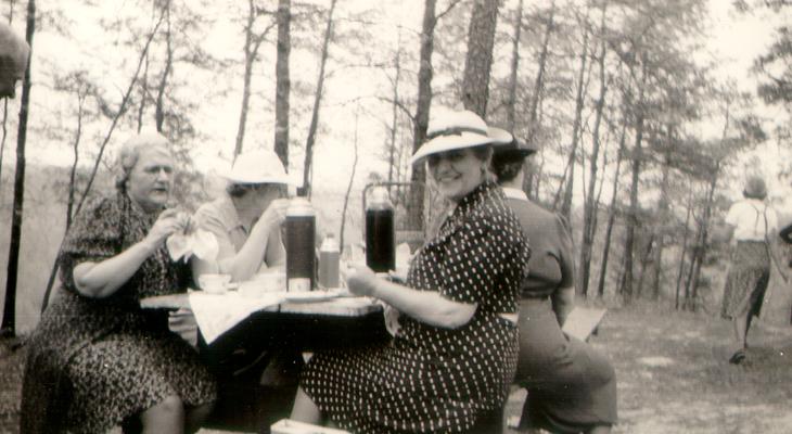 Four women at a picnic table